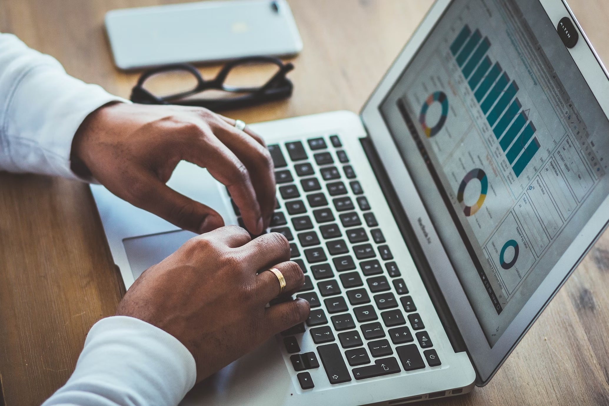 A person going through website analytics on a laptop.