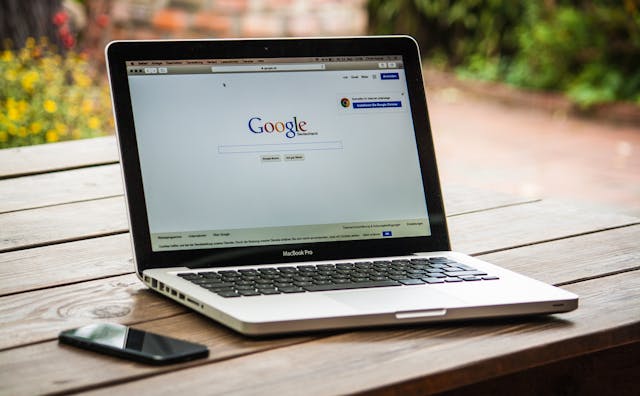 A laptop with the Google search engine on the screen